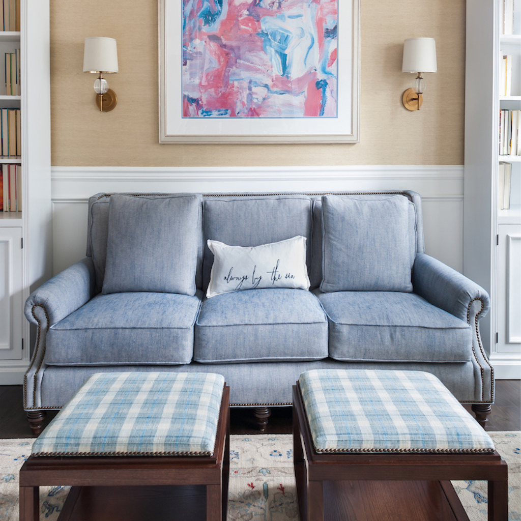 Gray sofa with plaid ottomans in a living room setting