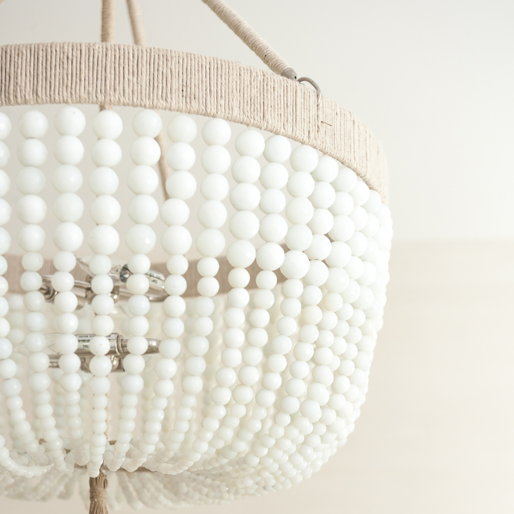 Close-up of a beaded chandelier with a neutral background