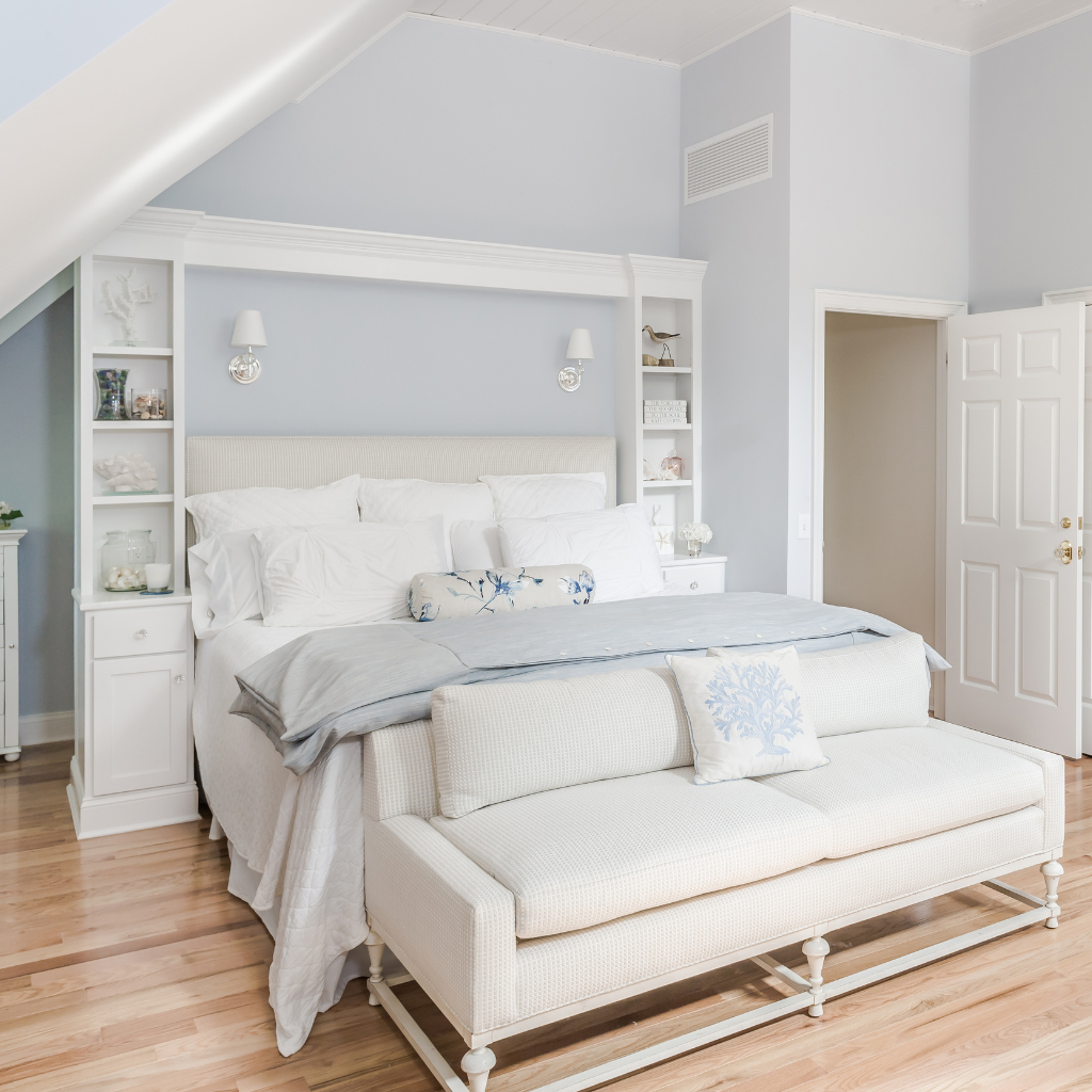 Modern bedroom with a bed and sofa bed in a light blue room.