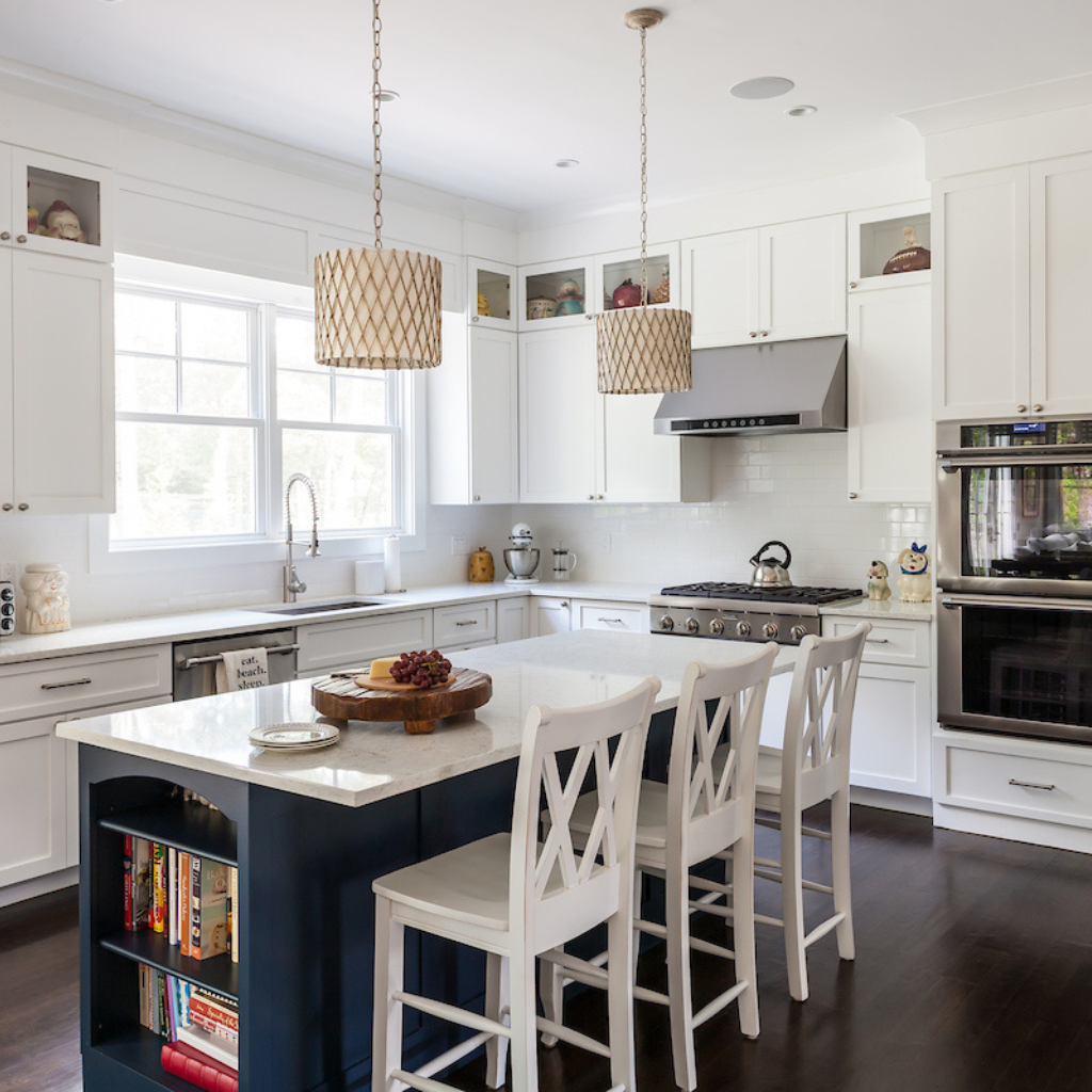 Modern kitchen with white cabinets, a central island, and stainless steel appliances.