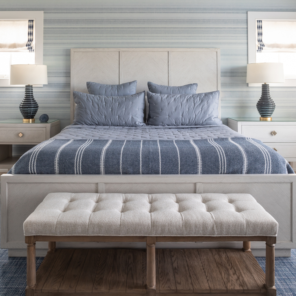 Bedroom with a bed, nightstands, and a bench.