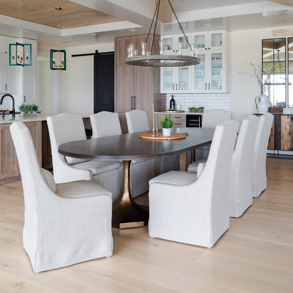 Dining room with a round table and white chairs in a modern kitchen.