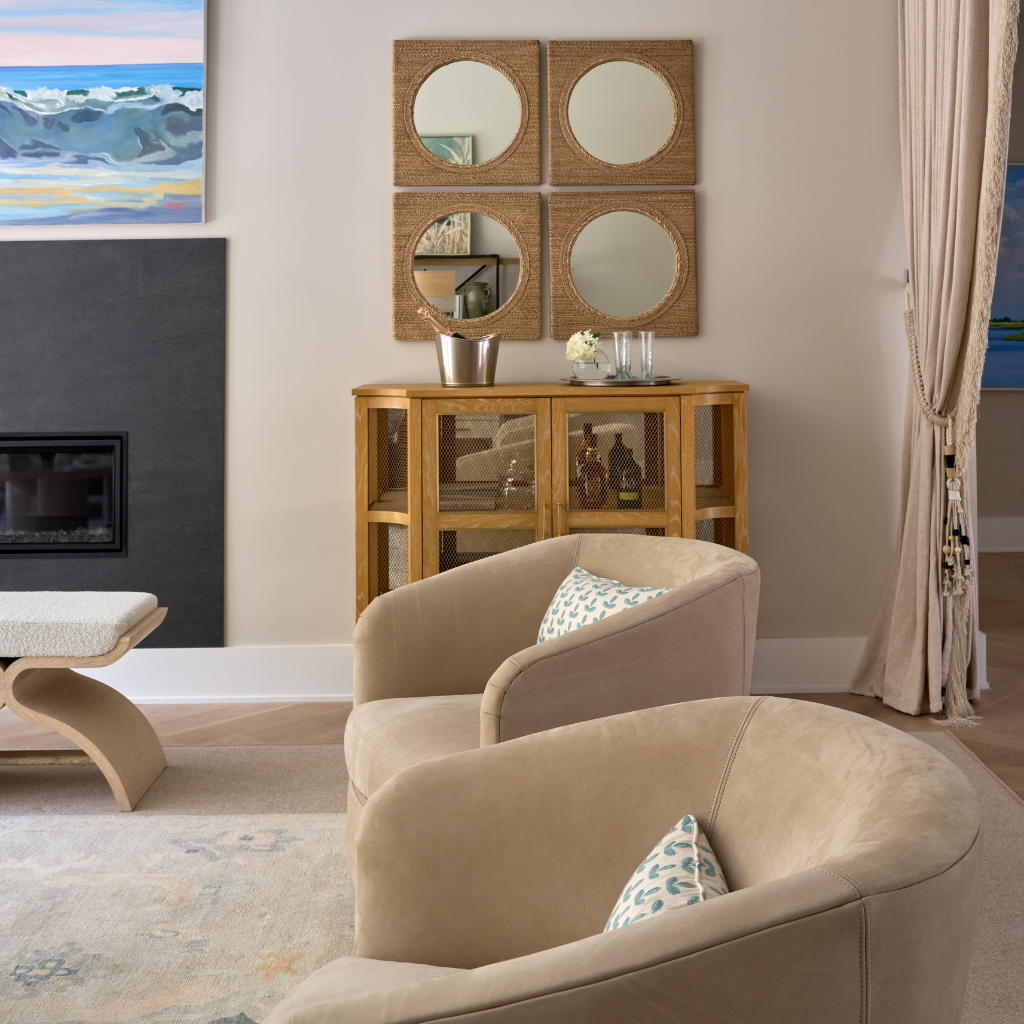 Living room with beige sofa, wooden side table, and wall mirrors.