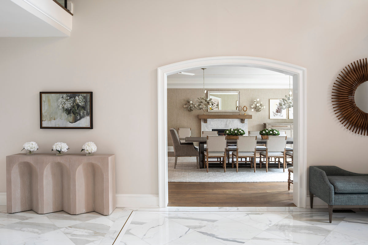 Modern interior with a console table, mirror, and sofa.