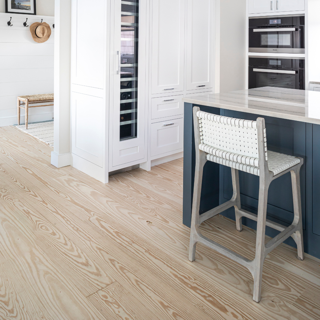 Modern kitchen with wooden floor and white cabinets