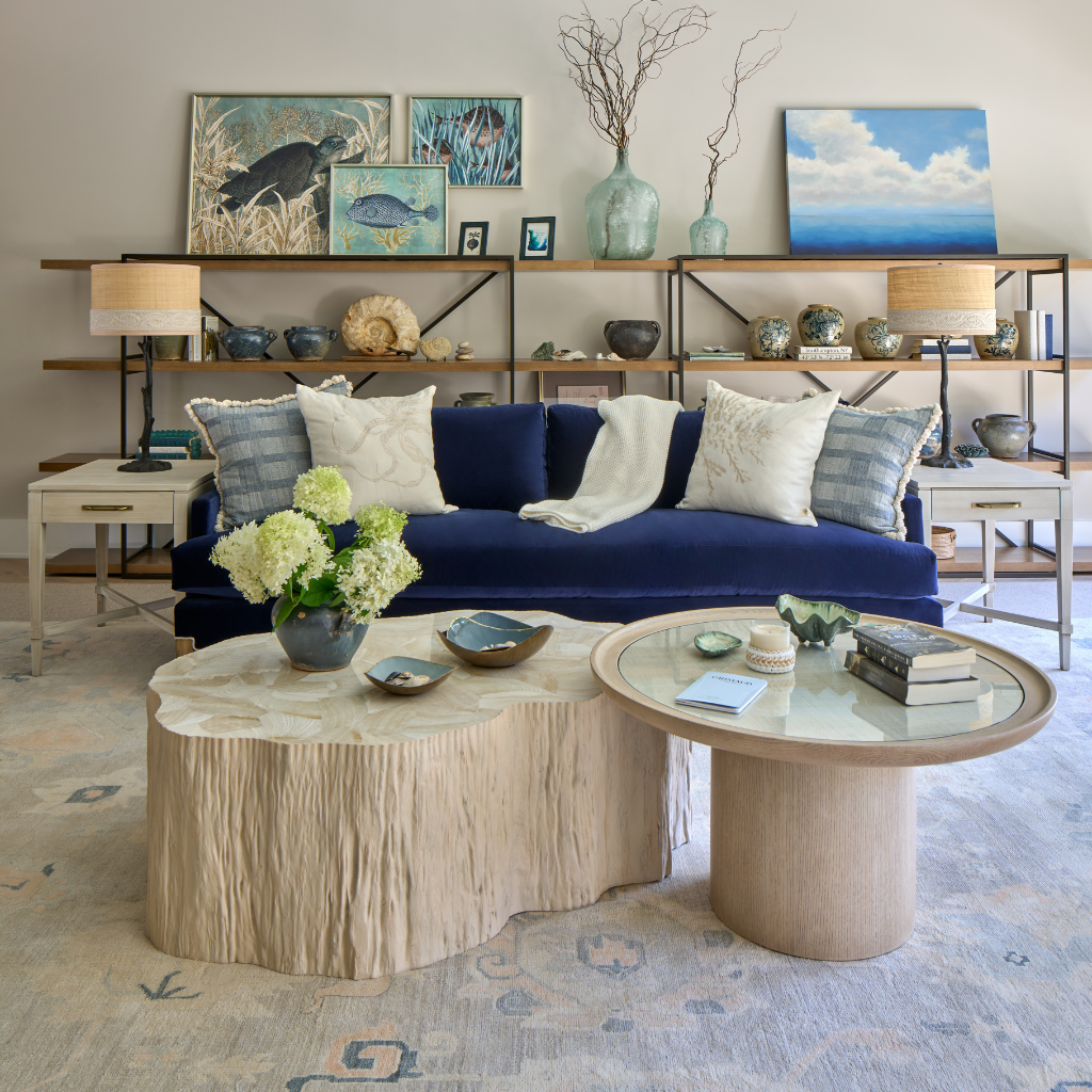 Living room with a blue sofa, wooden coffee table, and decorative elements.