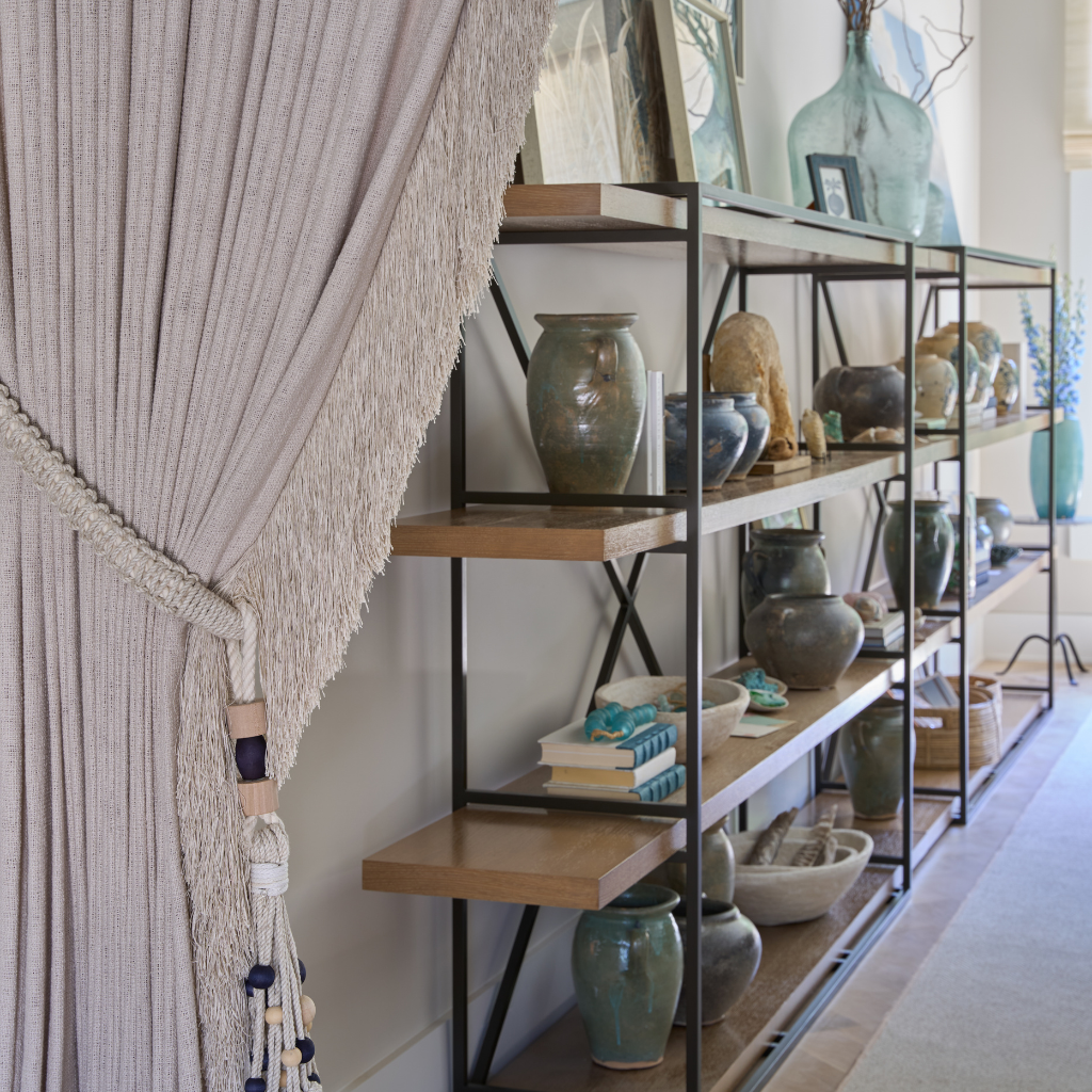 Shelving unit with decorative items against a neutral wall