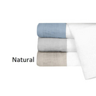 Stack of folded towels in natural color on a white background