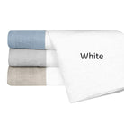 Stack of folded towels in white, gray, and blue on a white background with 'White' text.
