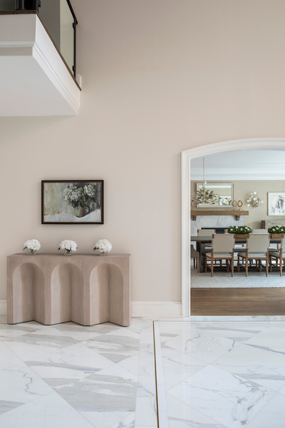 Modern interior with a console table, mirror, and framed artwork.