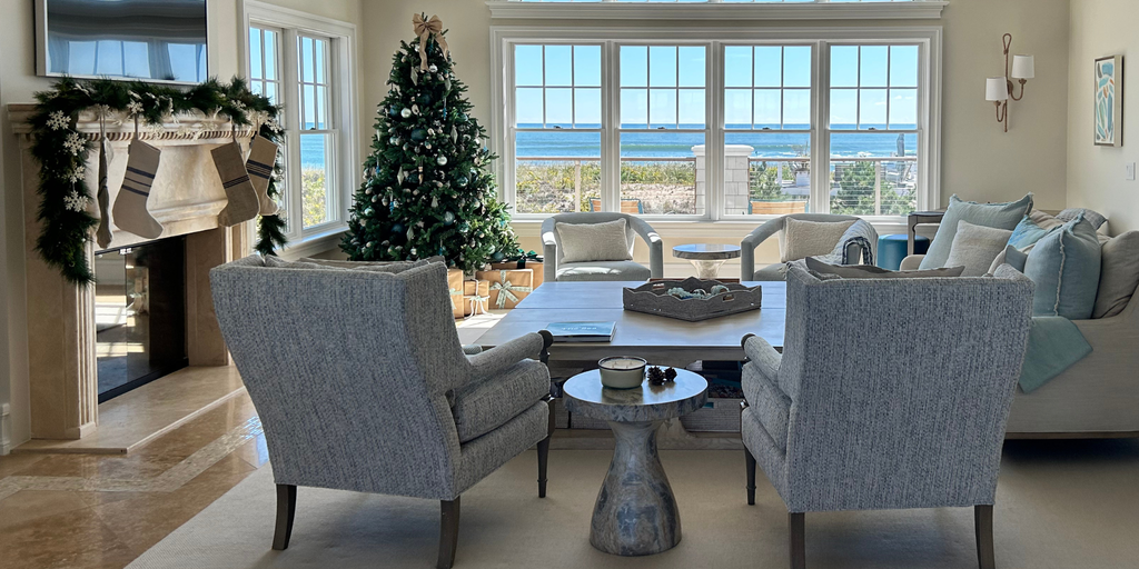 Living room with Christmas tree, fireplace, and ocean view