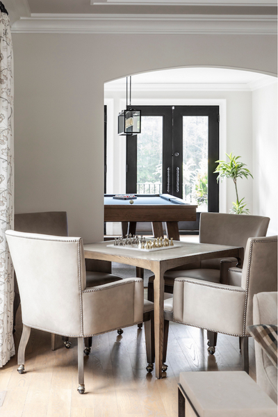 Dining room with a table and chairs in a modern interior setting.