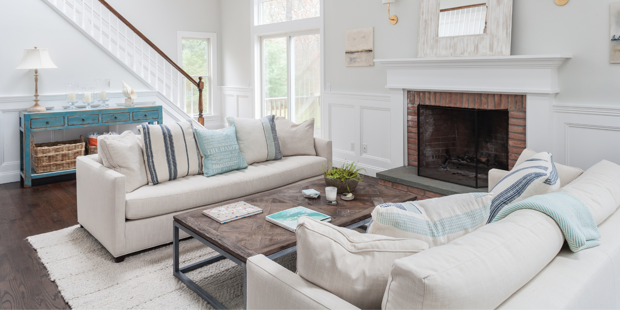 Living room with beige sofa, wooden coffee table, and fireplace.